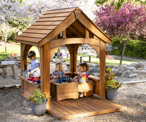 preschool kids playing in an outdoor playhouse