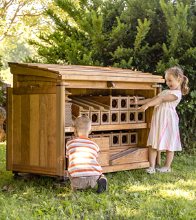 Children unloading blocks from Outlast Shed 44
