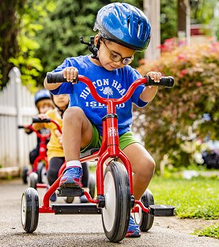 a child riding a tricycle