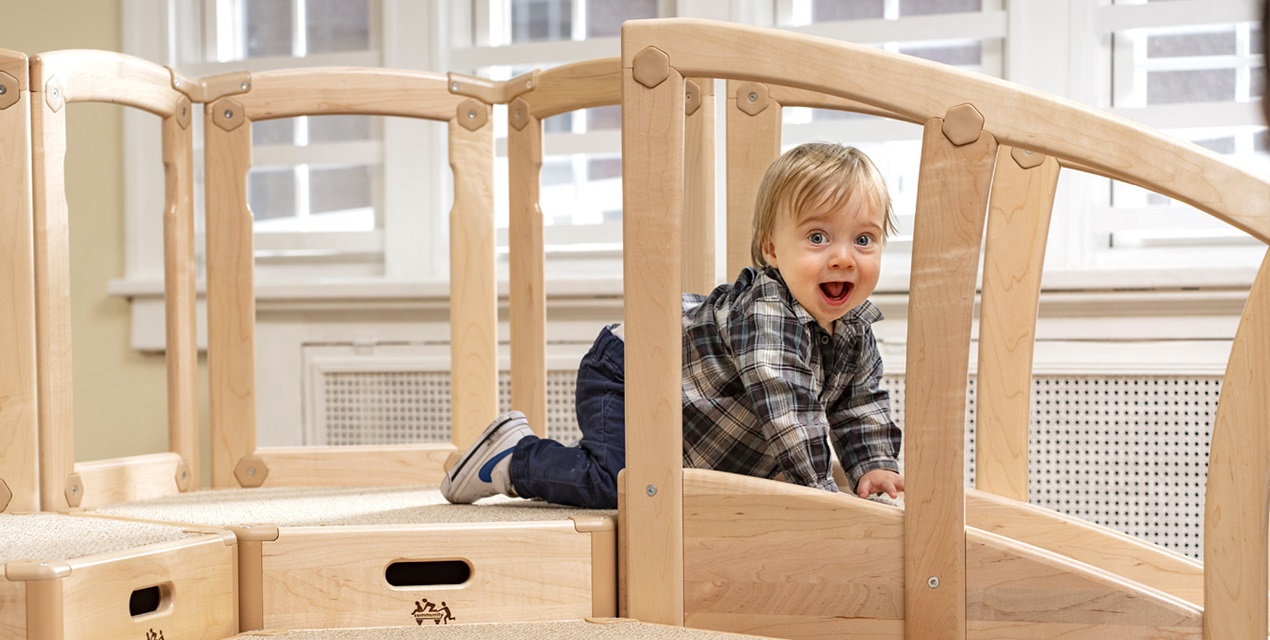 a child playing on an indoor climber