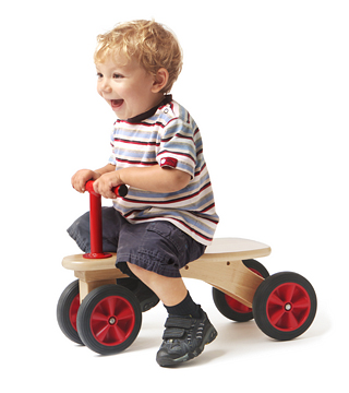 a child riding on a kiddie car