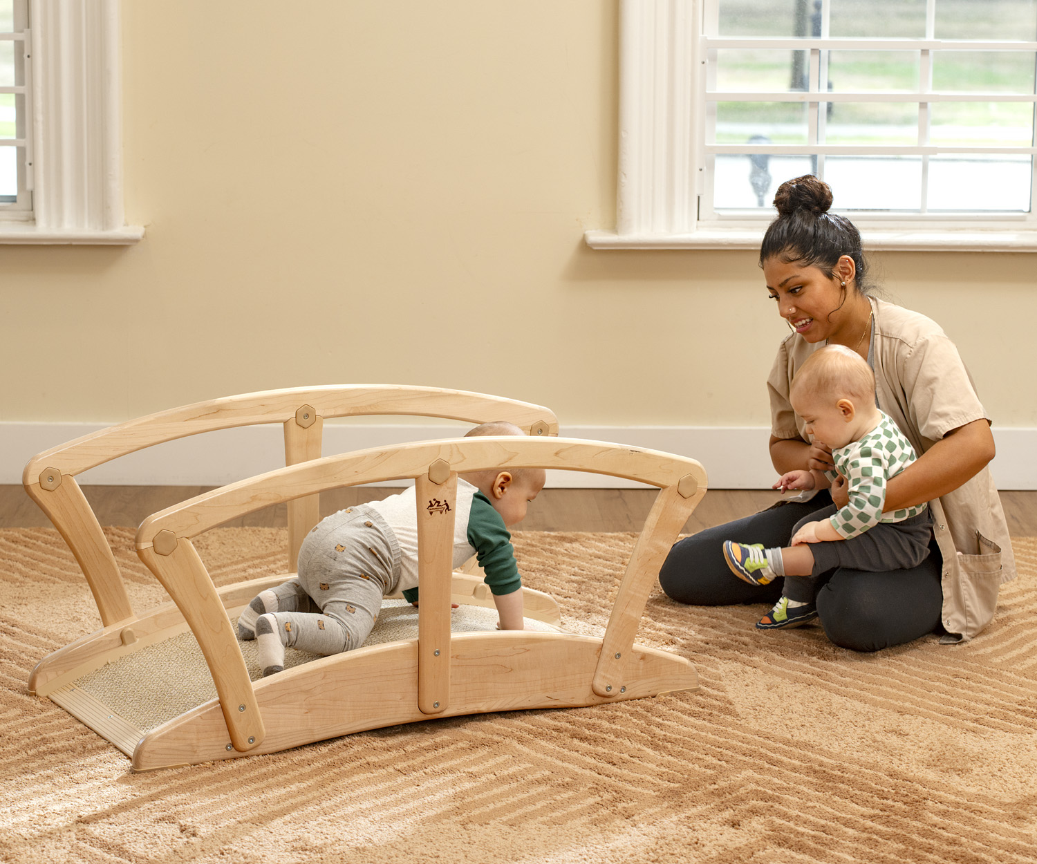a toddler playing on a wooden bridge