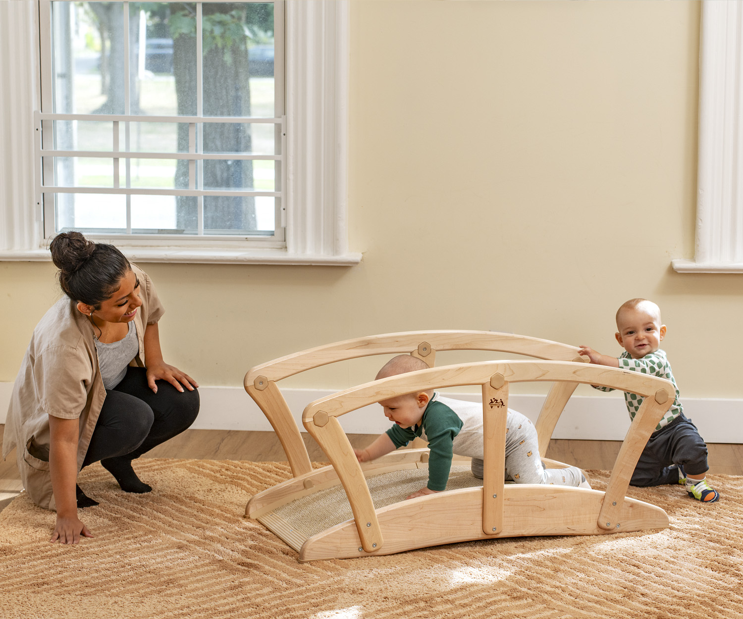 a toddler playing on a wooden bridge