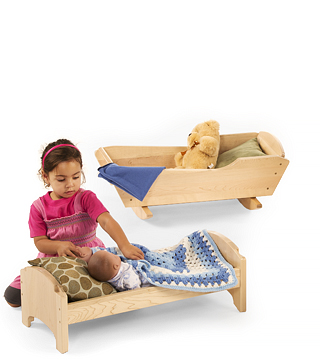 a girl putting a doll to bed