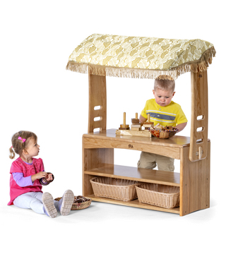 two children playing with a village store