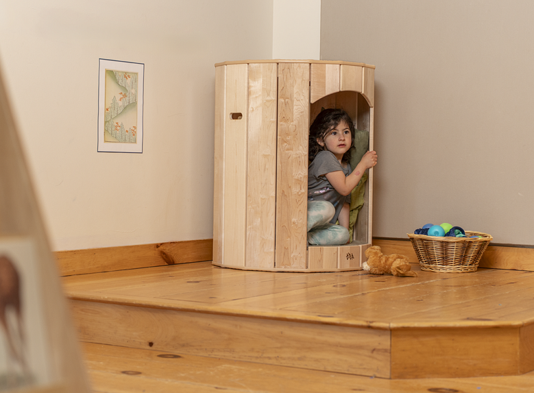 A child looking out from the Calm Nest.