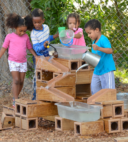 Children playing with water and Outlast blocks and ramps