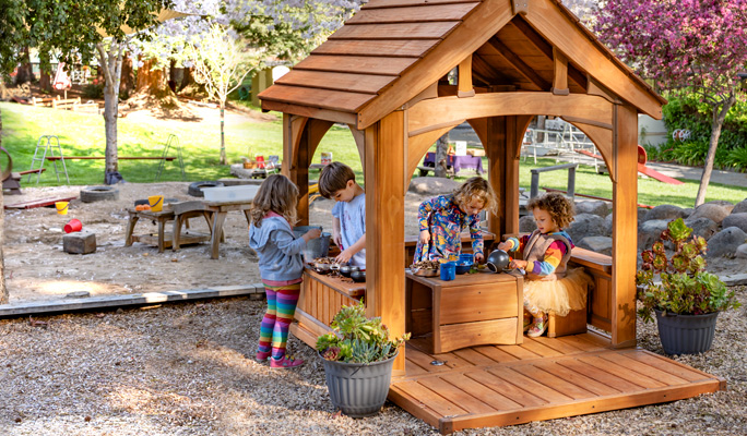 kids playing outdoors in playhouse