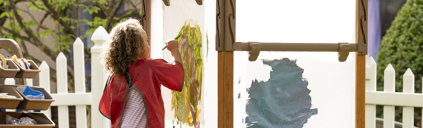 A child painting on an Outlast easel