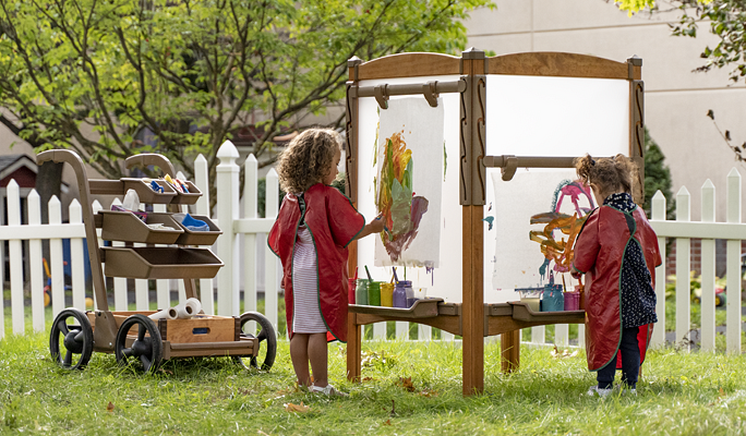 Children painting on an Outlast easel